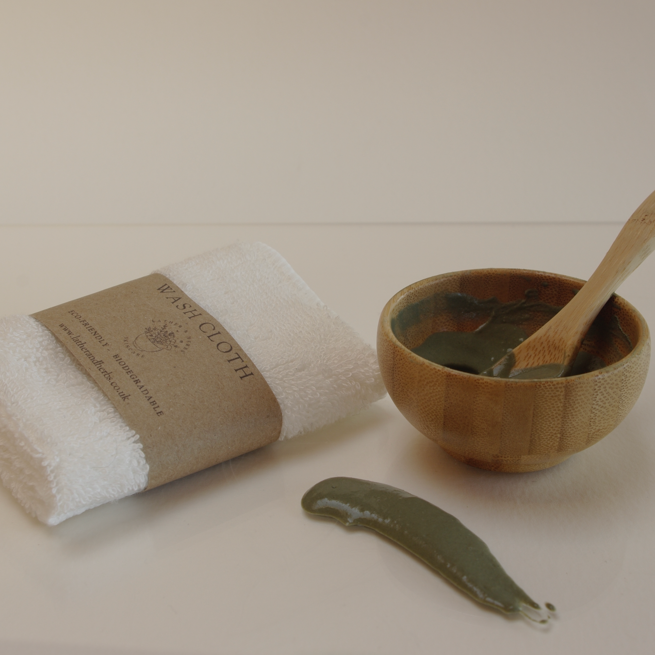 Bamboo mini bowl and spoon with green clay and a wash cloth