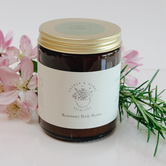 Amber glass jar with gold lid blossom and a rosemary sprig