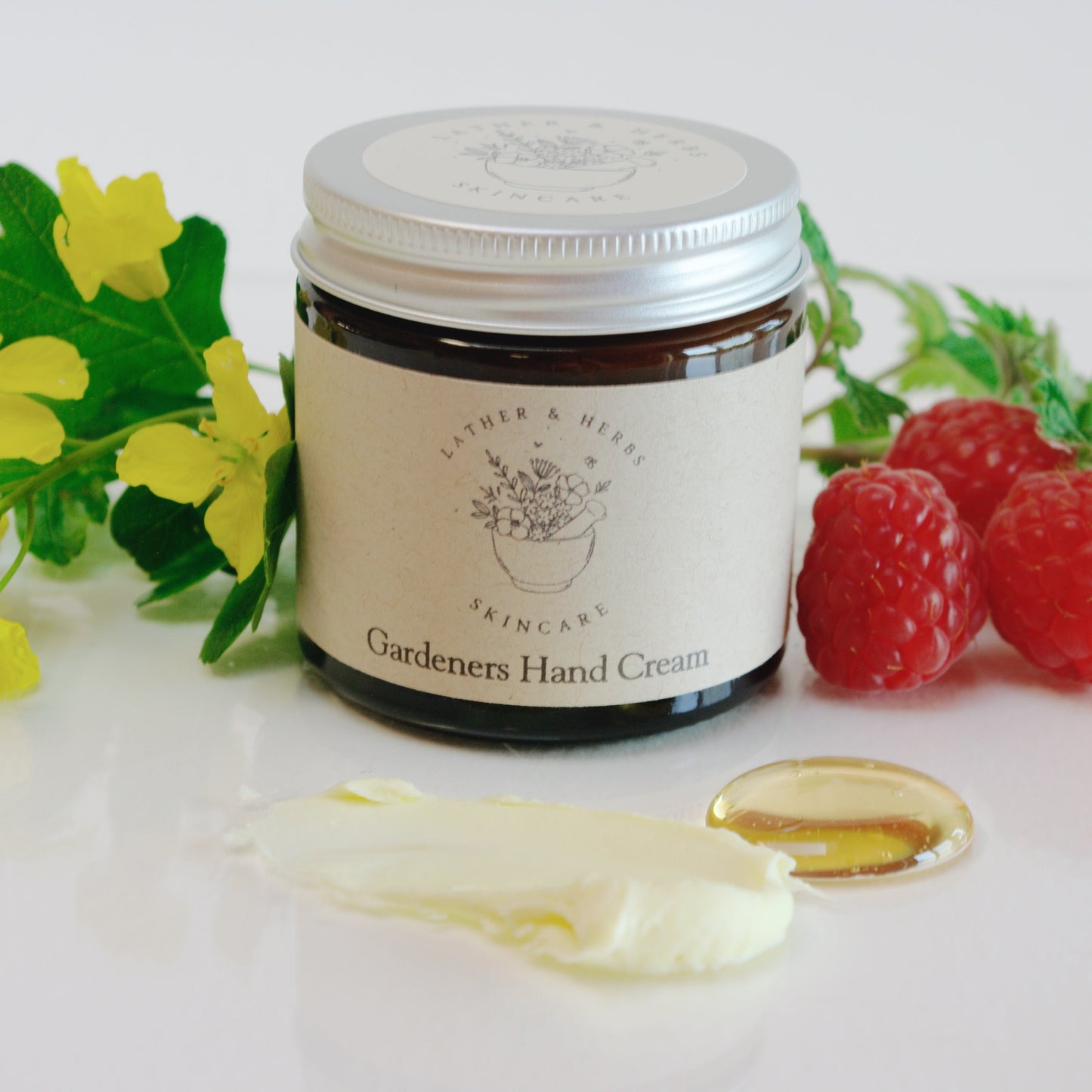 Amber glass jar with raspberry and rapeseed flowers