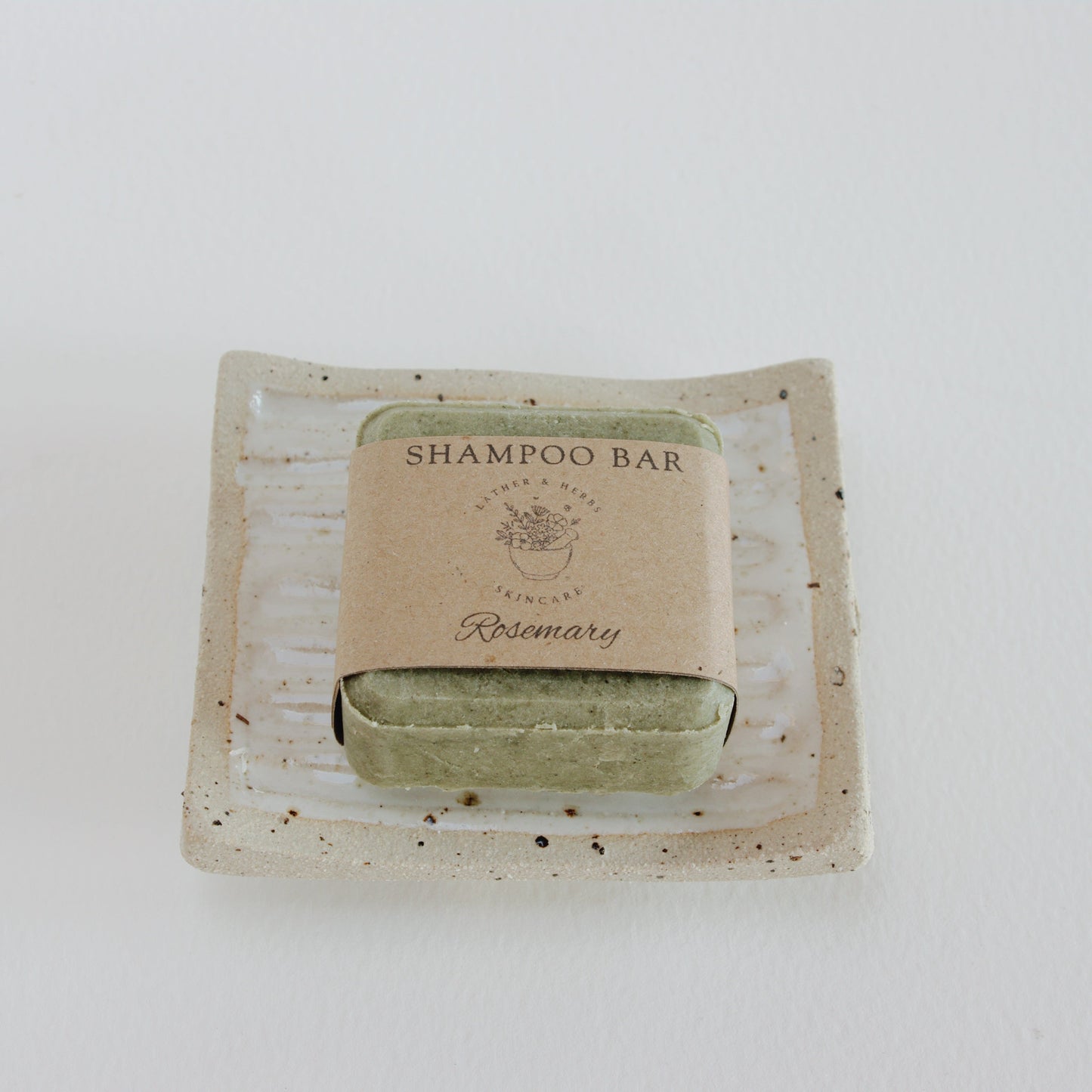 Green Nettle Shampoo Bar on a hand made ceramic soap dish