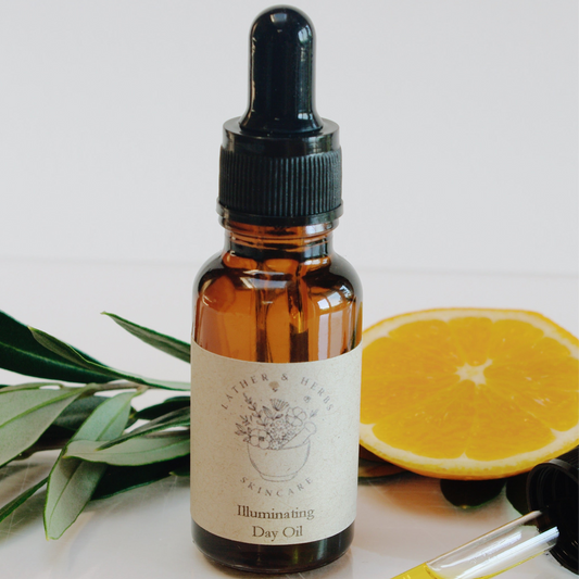 amber glass dropper bottle with pipette and olive sprig and and orange slice