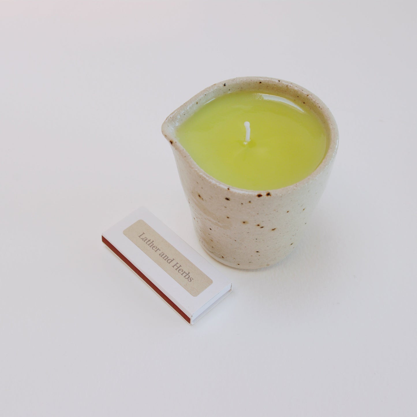 Lavender & Geranium massage candle in a handmade ceramic ju
