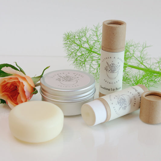 Round aluminium tin and cardboard tube with lip butter disc and a rose and botanical twig