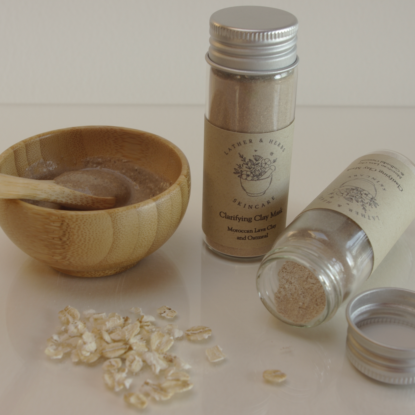 Oatmeal & Rhassoul Clay Face Mask with a bamboo bowl and spoon and oats