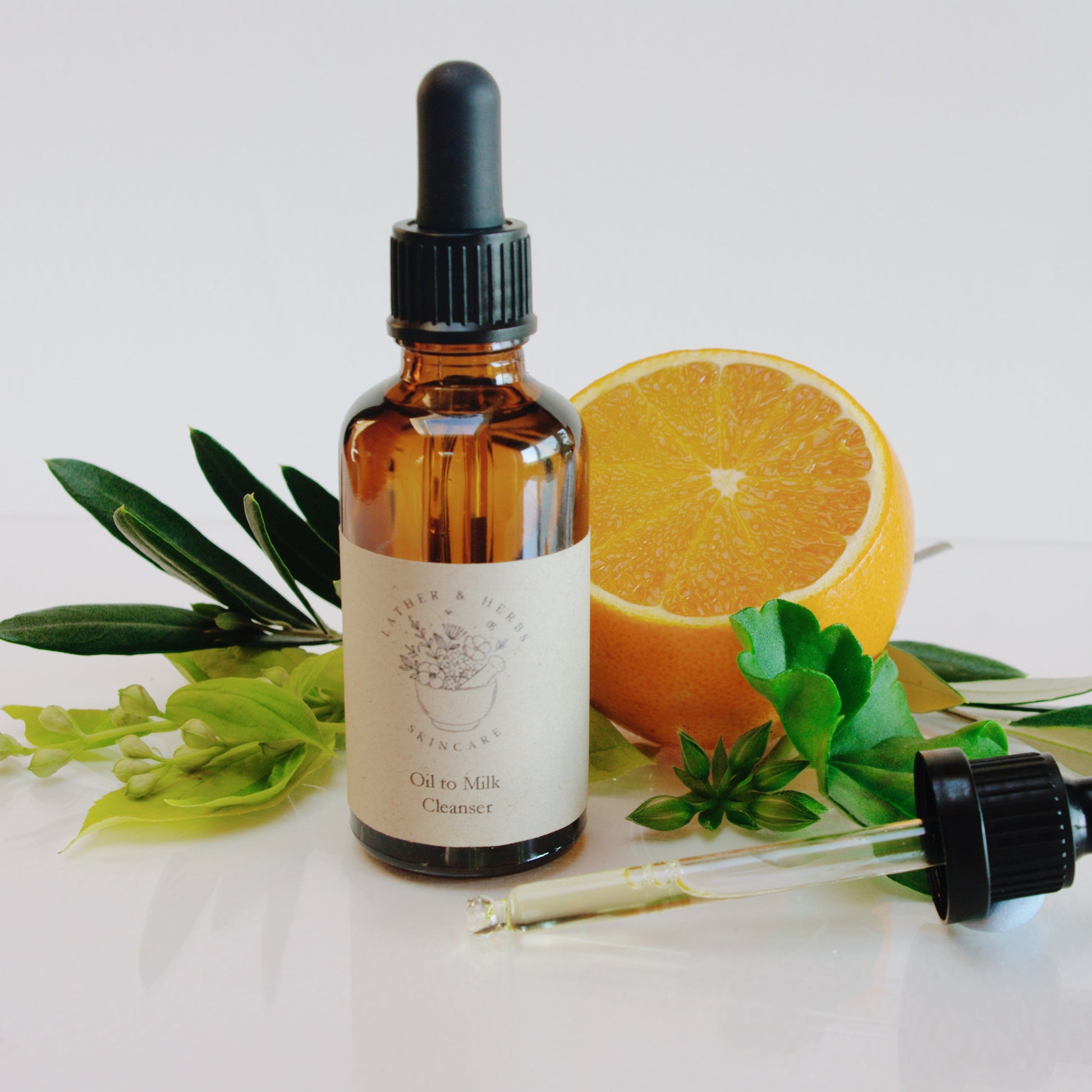 Amber glass bottle with dropper botanical sprigs and an orange