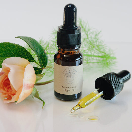 Amber glass bottle with dropper and a rose and botanical sprig