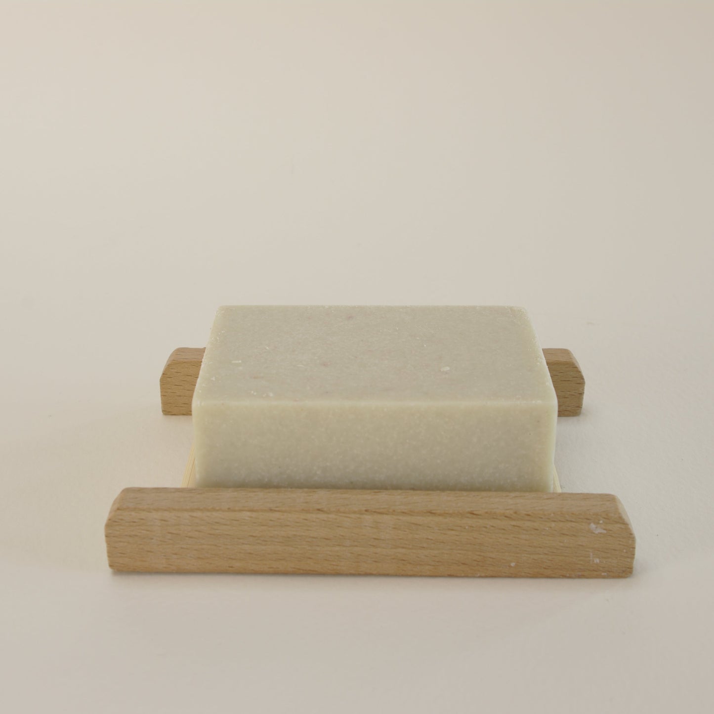 Natural rosemary salt soap with Himalayan and Sea Salt on a bamboo soap rack
