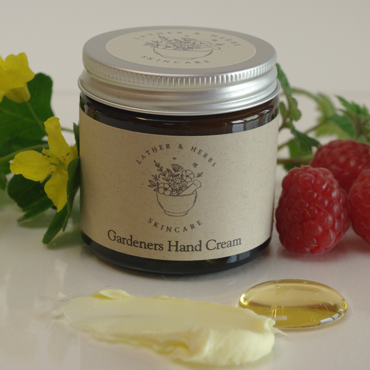 Amber glass jar with Gardeners Hand cream and cream and honey with raspberries and rapeseed flowers