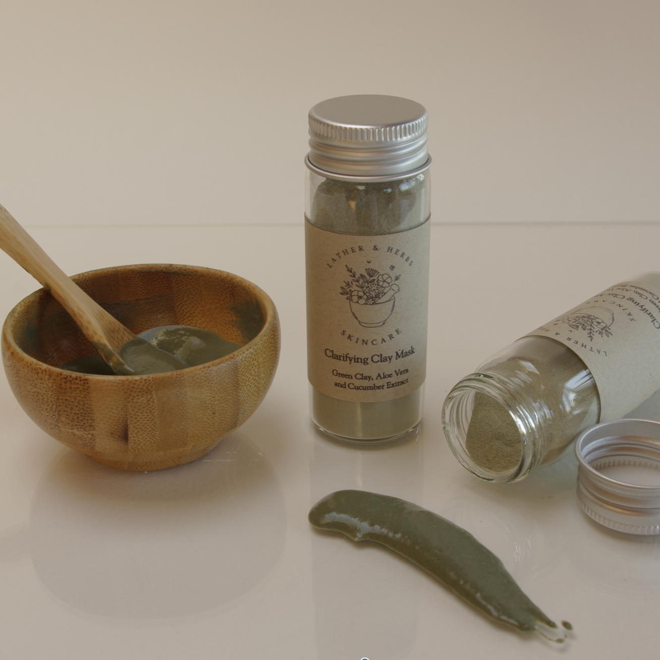 Green clay mask with aloe vera and cucumber extract with bamboo mini bowl and spoon with clay spread