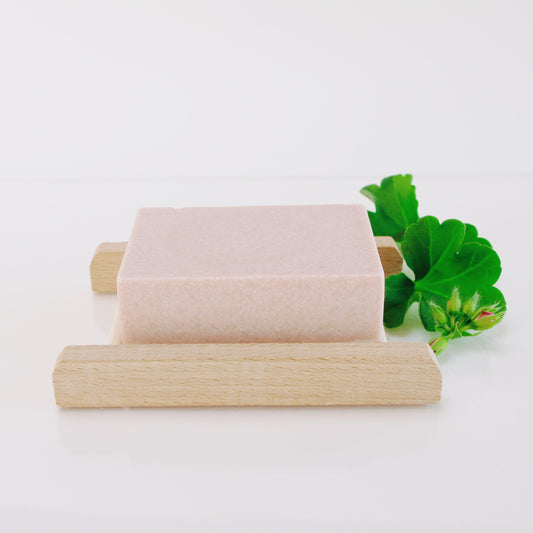 Geranium himalayan salt soap on a bamboo rack and geranium leaf