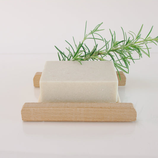 Himalayan Salt Soap on a bamboo rack with a sprig of rosemary
