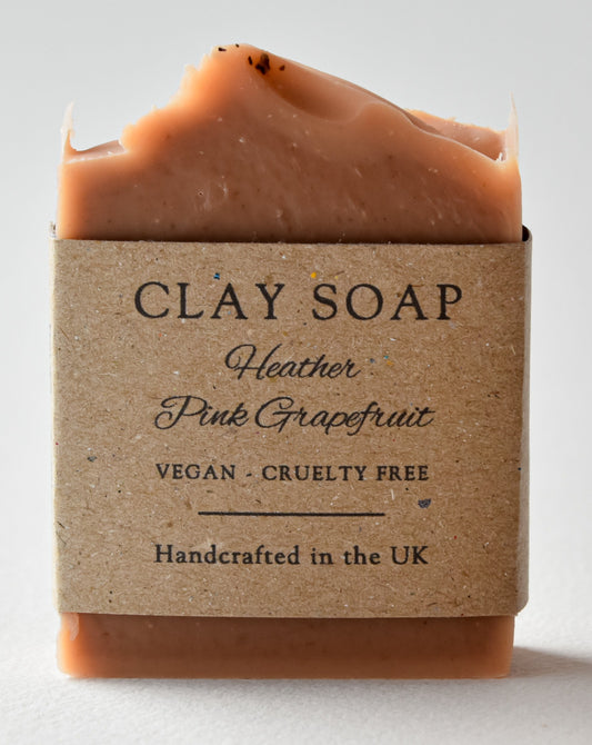 deep red clay soap bar with recycled paper label 