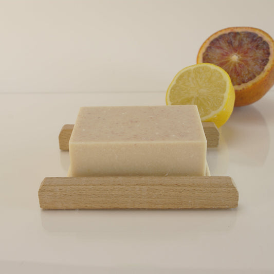 Natural salt soap bar with Himalayan and Sea Salt, Lemon & Grapefruit essential oils on a bamboo soap rack with a lemon and orange 