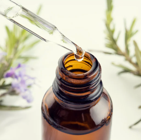 rosemary oil dropper into bottle 