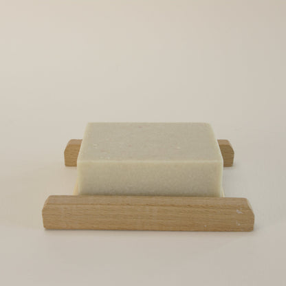 Natural rosemary salt soap with Himalayan and Sea Salt on a bamboo soap rack