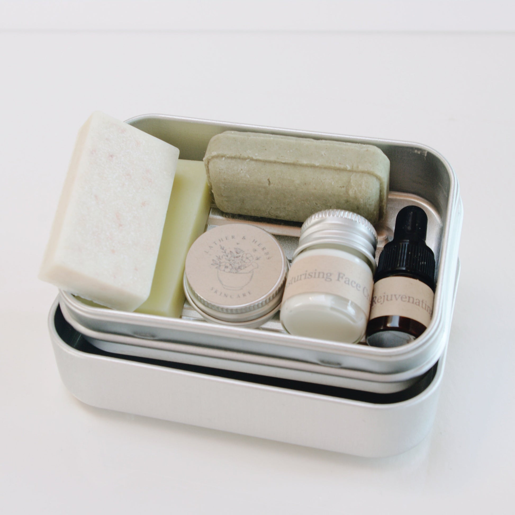 Set of skincare products in a small container on a white background