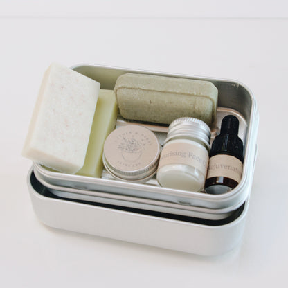 Set of skincare products in a small container on a white background